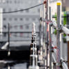 A close-up image of scaffolding consisting of metal poles and wooden planks arranged in a criss-cross pattern.